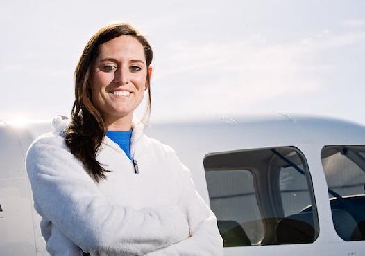 Woman standing in front of plane