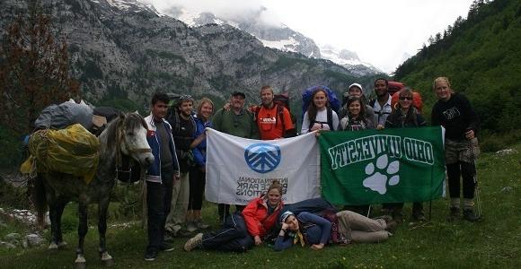 people holding ohio university flag