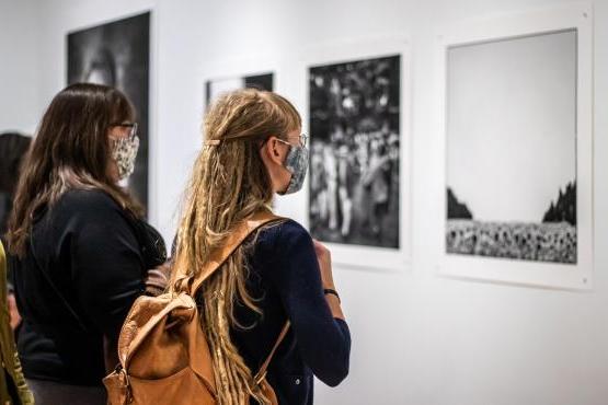 People in gallery looking at artwork