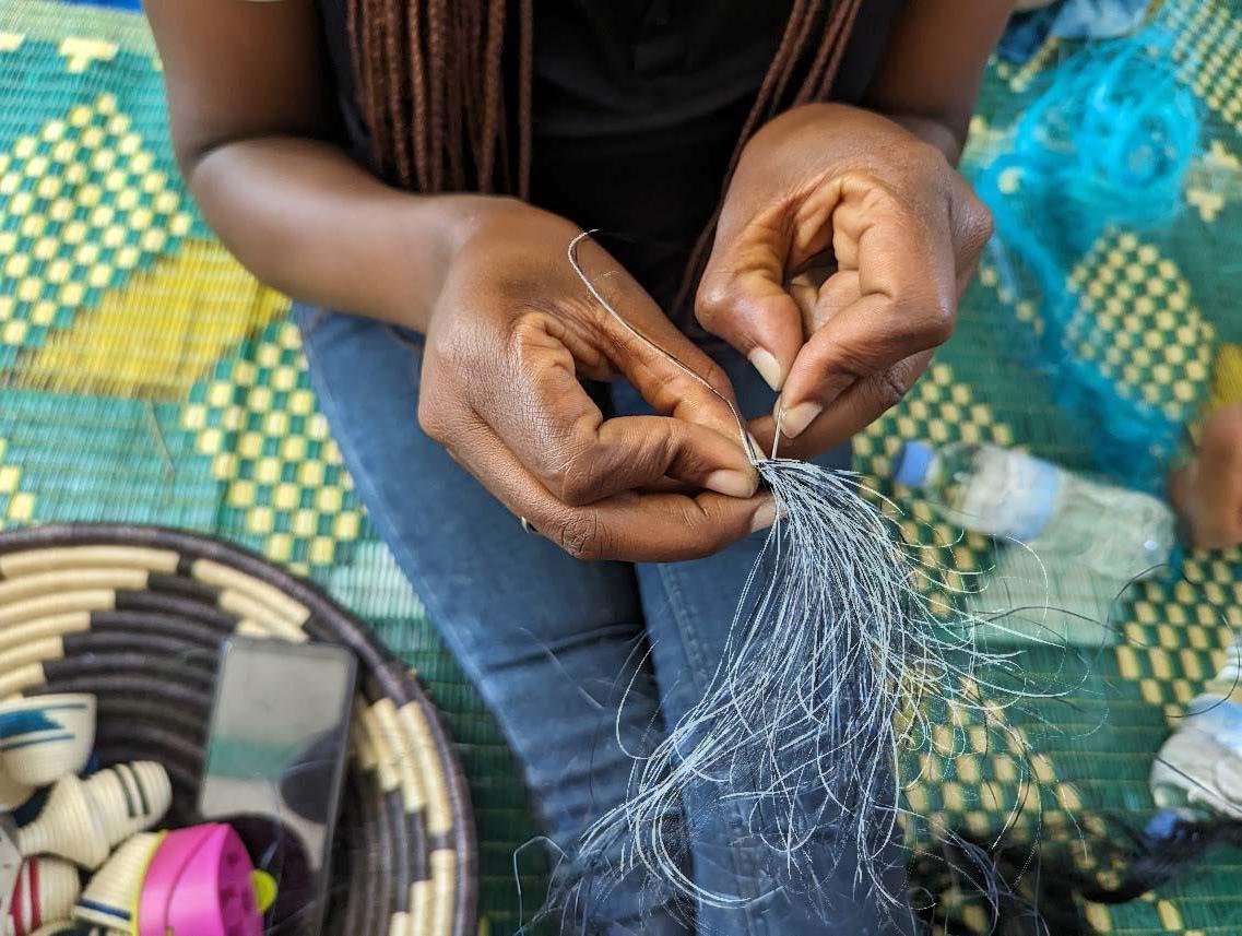 A weaver working with thread